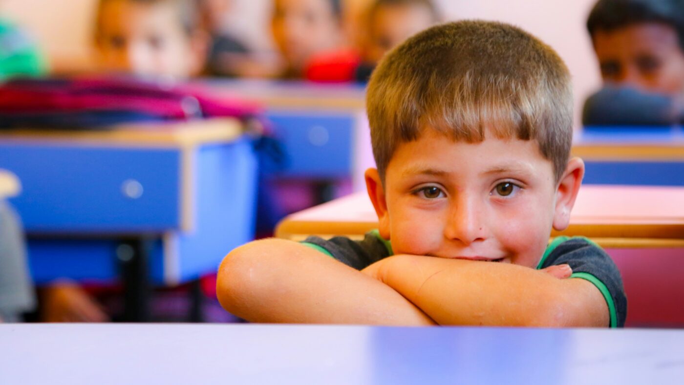 Child experiencing back-to-school anxiety with support from a parent